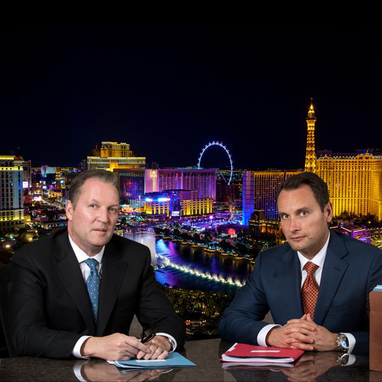 Bradley J. Hofland and Josh Tomsheck with Las Vegas skyline in the background.