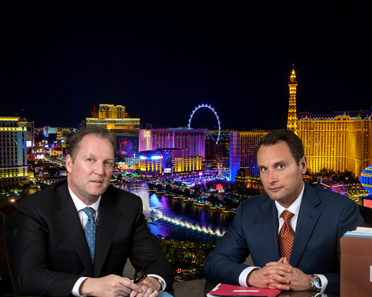 Bradley J. Hofland and Josh Tomsheck with Las Vegas skyline in the background.